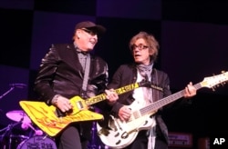 FILE - Rick Nielsen and Tom Petersson of the band Cheap Trick perform in concert at the American Music Theatre in Lancaster, Pa., June 6, 2014.