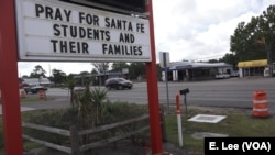Businesses throughout the town of Santa Fe, Texas, post signs in support of the survivors and the loved ones of those killed in the high school shooting May 18, 2018.