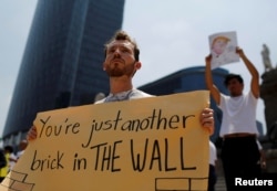 FILE - A demonstrator protests against the visit of U.S. Republican presidential candidate Donald Trump at the Angel of Independence monument in Mexico City, Mexico, Aug. 31, 2016.