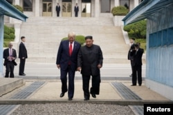 U.S. President Donald Trump meets with North Korean leader Kim Jong Un at the demilitarized zone separating the two Koreas, in Panmunjom, South Korea, June 30, 2019.