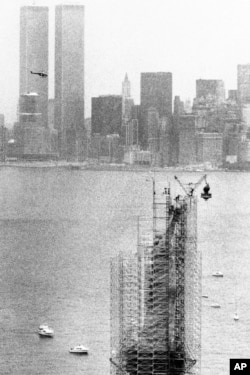 FILE - This July 4,1984, photo shows the original torch of the Statue of Liberty after it was removed from her grasp in New York. The torch, which was replaced by a replica, was moved into what will become its permanent home at a new museum on Liberty Island.
