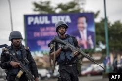 FILE - Members of the Cameroonian Gendarmerie patrol in the Omar Bongo Square of Cameroon's majority anglophone South West province capital Buea during a rally in support of Cameroonian President Paul Biya, Oct. 3, 2018.