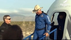 This photo provided by Blue Origin, Jeff Bezos, founder of Amazon and space tourism company Blue Origin, exits the Blue Origin's New Shepard capsule after it parachuted safely down to the launch area. (Blue Origin via AP)