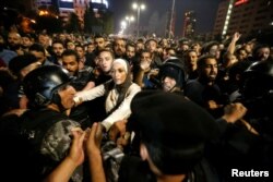 Demonstrators clash with riot police during a protest in Amman, Jordan, June 2, 2018.