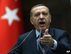 Turkey's Prime Minister Recep Tayyip Erdogan addresses supporters and lawmakers at the parliament in Ankara, Turkey, May 14, 2013.