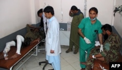 Wounded Afghan National Army (ANA) soldiers receive treatment in a hospital after a suicide bomber blew himself up inside a packed mosque on an Afghan army base in Khost province, Nov. 23, 2018.