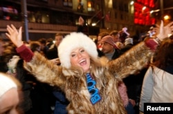 A woman takes part in the Hogmanay (New Year) street party celebrations in Edinburgh, Scotland, January 1, 2014. (REUTERS/Russell Cheyne)