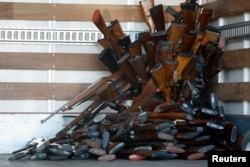 FILE - A truck holds a small portion of guns turned in by owners at a buy-back program of the Los Angeles Police Department in California, Dec. 26, 2012, following the mass shooting at Sandy Hook Elementary School.