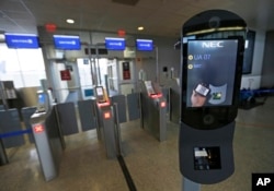 FILE - A U.S. Customs and Border Protection facial recognition device is ready to scan another passenger at a United Airlines gate.