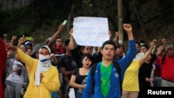 People support Honduran police during a strike to demand higher wages and rest after working extra hours due to protests caused by the delay in vote counting in the general election, at their headquarters in Tegucigalpa, Honduras, Dec. 4, 2017.
