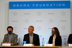 Former U.S. President Barack Obama sits next to Nima Tisdall from Denmark, right, and Rachid Ennassiri from Morocco during a roundtable meeting at the COP26 U.N. Climate Summit in Glasgow, Scotland, Nov. 8, 2021.