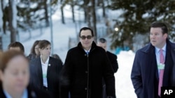 Steven Mnuchin, United States Secretary of the Treasury, walks through the snow during the annual meeting of the World Economic Forum in Davos, Switzerland, Jan. 24, 2018.