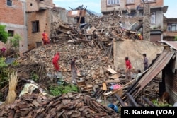 A family searches for any valuables they can find in their destroyed home, Sankhu, Nepal, April 29, 2015.