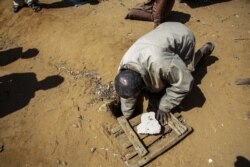 Jonarson Revoria, 73, a farmer, shows a small basin dug in the ground to collect rainwater in the village of Ankilidoga, Commune of Sampona, Madagascar, August 31, 2021. But it has not been filled since July.