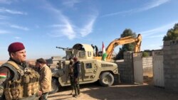 Kurdish Peshmerga forces oversee digging of defensive trenches in the village of Lheiban , Iraq, Dec. 7, 2021.