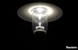 FILE - A light-emitting diode (LED) street lamp is illuminated in Langen, Lower Saxony. Experts say LED is not just environment-friendly; it helps consumers save money and enables the government to fill energy gaps.