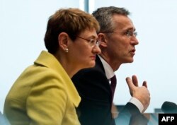 FILE - NATO Secretary-General Jens Stoltenberg, with NATO spokeswoman Oana Lungescu, addresses reporters in Berlin, Jan. 14, 2015.