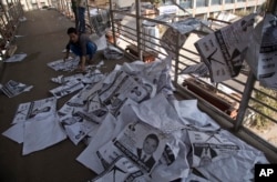 A Bangladeshi man collects election posters in Dhaka, Bangladesh, Monday, Dec. 31, 2018.