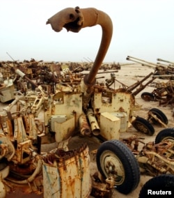 FILE - A destroyed anti-aircraft gun lies in a scrapyard in the Kuwait desert containing the remnants of an Iraqi army destroyed by coalition forces during the Gulf War. Nov. 5, 2002.