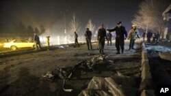 FILE - Afghan security forces inspect the site of a suicide attack near the Russian embassy in Kabul, Afghanistan, Jan. 20, 2016.