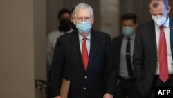 FILE - Then-Senate Majority Leader Mitch McConnell, Republican of Kentucky, walks to his office from the Senate floor at the U.S. Capitol in Washington, Dec. 18, 2020. 