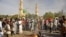 People gather at the site of a bomb explosion in Kano, Nigeria, Friday Nov. 28, 2014. An explosion tore through the central mosque in Nigeria's second-largest city on Friday, and officials feared the casualty toll would be high. Capt. Ikechukwu Eze said t