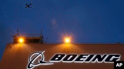 FILE - A sign on Boeing's 737 delivery center, Oct. 19, 2015, at Boeing Field in Seattle. A Southwest Airlines jet leaving Denver was forced to land after the engine cover fell off and struck the wing flap during takeoff. The Boeing 737 landed safely April 7, 2024.