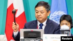 The president of the U.N.-backed COP15 biodiversity conference, China's Minister of Ecology and Environment Huang Runqiu, lowers the gavel to pass the The Kunming-Montreal Global Biodiversity Framework in Montreal, Quebec, Canada, Dec. 19, 2022. 