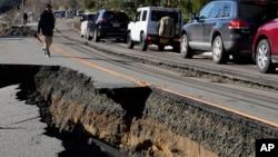 A traffic jam is seen on a partially collapsed road caused by powerful earthquake near Anamizu Town, Ishikawa Prefecture Tuesday, Jan. 2, 2024.