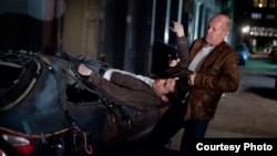 Joseph Gordon-Levitt and Bruce WIllis as "Joe" in TriStar Pictures, Film District, and End Game Entertainment's action thriller LOOPER.