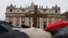 Pilgrims hold a cross in front of St. Peter's Basilica while cardinals meet in the Sistine Chapel to elect a new pope, at the Vatican, March 13, 2013. 