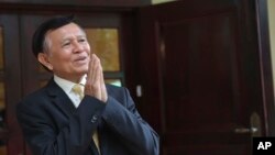 FILE - Cambodia National Rescue Party's President Kem Sokha greets to journalists in his house in Phnom Penh, Cambodia, Nov. 12, 2019. 