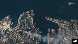 FILE - In this satellite photo provided by Planet Labs, smoke billows from a headquarters building for the Russian Black Sea fleet in Sevastopol, Crimea on Sept. 22, 2023, after it was struck in a missile attack launched by the Ukrainian military.