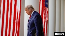 U.S. President Donald Trump walks down the West Wing colonnade from the Oval Office to the Rose Garden to speak to the press, at the White House in Washington, Nov. 13, 2020.