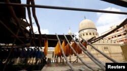 Colored yarns are hung up to dry on the roof of a dye workshop in old Cairo, Egypt, March 17, 2016. 