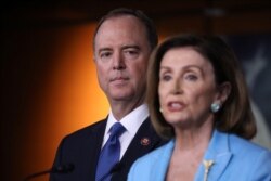 U.S. House Speaker Nancy Pelosi (D-CA) addresses reporters as House Intelligence Committee Chairman Adam Schiff (D-CA) looks on during Pelosi's weekly news conference at the U.S. Capitol in Washington, Oct. 2, 2019.