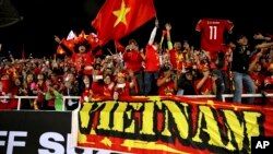 Vietnam's spectators cheers during the AFF Suzuki Cup final match between Vietnam and Malaysia at My Dinh stadium in Hanoi, Vietnam Dec. 15, 2018.