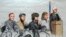 In this courtroom sketch, Boston Marathon bombing suspect Dzhokhar Tsarnaev, third from right, is depicted with his lawyers and U.S. District Judge George O'Toole Jr. at the federal courthouse in Boston Jan. 6, 2015.