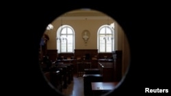 FILE - A view shows the courtroom after the initial extradition hearing for Rwandan genocide suspect Felicien Kabuga, at the Paris courthouse, France, May 20, 2020. 