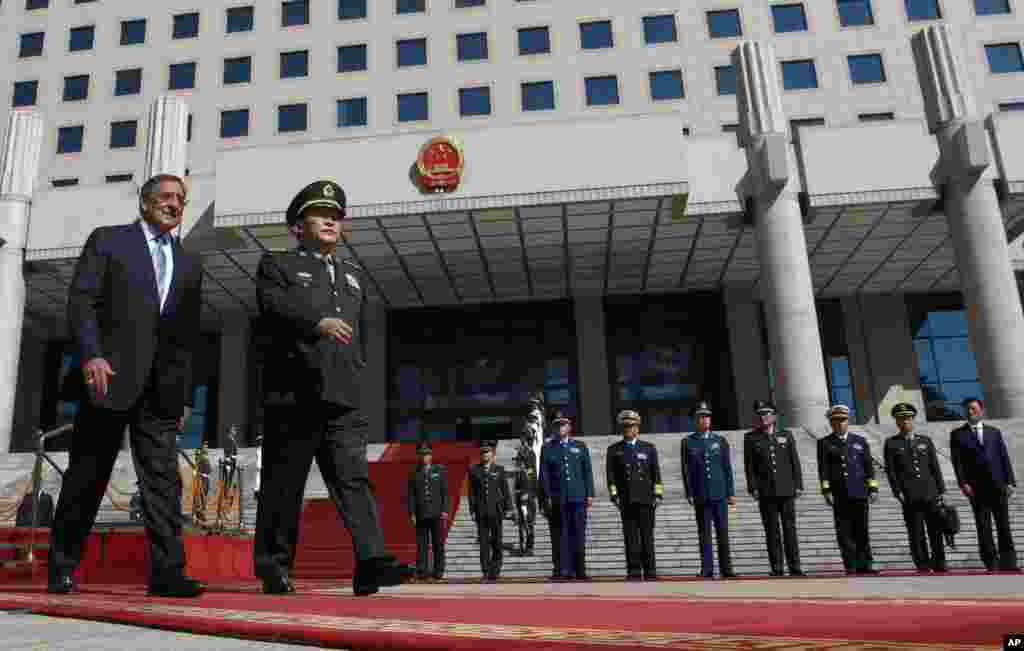 U.S. Defense Secretary Leon Panetta, left, walks with Chinese Defense Minister Liang Guanglie during a ceremony at the Bayi Building in Beijing, China, September 18, 2012.