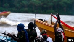 Des combattants du Mouvement pour l'émancipation du Delta du Niger (MEDN) patrouillent dans les ruisseaux de la rivière Bonny, près de l'usine de GNL, dans la région pétrolière du delta du Niger, dans le sud du Nigeria, 18 septembre 2008. EPA / GEORGE Esi