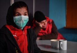 Homeless people are pictured at the Parada foundation in Bucharest, Romania, on March 24, 2020.