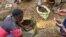 FILE - An artisanal miner washes tin ore before it is bagged up and weighed, ready to be transported to the nearest major town for export in the Kalimbi tin mine near the small town of Nyabibwe, D.R.C.