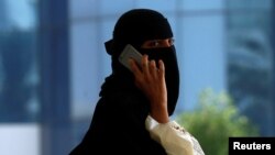 FILE - A Saudi woman speaks on the phone in Riyadh, Saudi Arabia, Oct. 2, 2017.