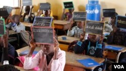 Second-graders in Alieu Samb primary school hold up chalk boards with French conjugations. Dakar, Senegal, Dec. 7 2017. (Photo: Sofia Christensen for VOA) 