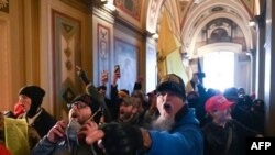 FILE - Supporters of U.S. President Donald Trump protest inside the U.S. Capitol, Jan. 6, 2021.
