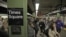 Passengers exit a subway train at New York's Times Square station, Nov. 1, 2012. 