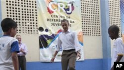 U.S. President Barack Obama plays soccer with local children during his tour of the Ciudad de Deus Favela in Rio de Janeiro, Brazil, Sunday, March 20, 2011.