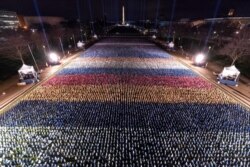 Flags are placed on the National Mall, with the Washington Monument behind them, ahead of the inauguration of President-elect Joe Biden and Vice President-elect Kamala Harris, in Washington, Jan. 18, 2021.
