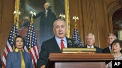 Israeli Prime Minister Benjamin Netanyahu, accompanied by House of Representatives members, gestures during a news conference on Capitol Hill in Washington, March 6, 2012.